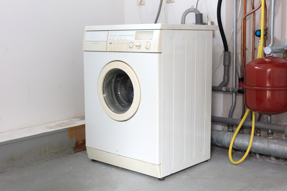 Old,dirty,washing,machine,on,the,attic,,door,closed