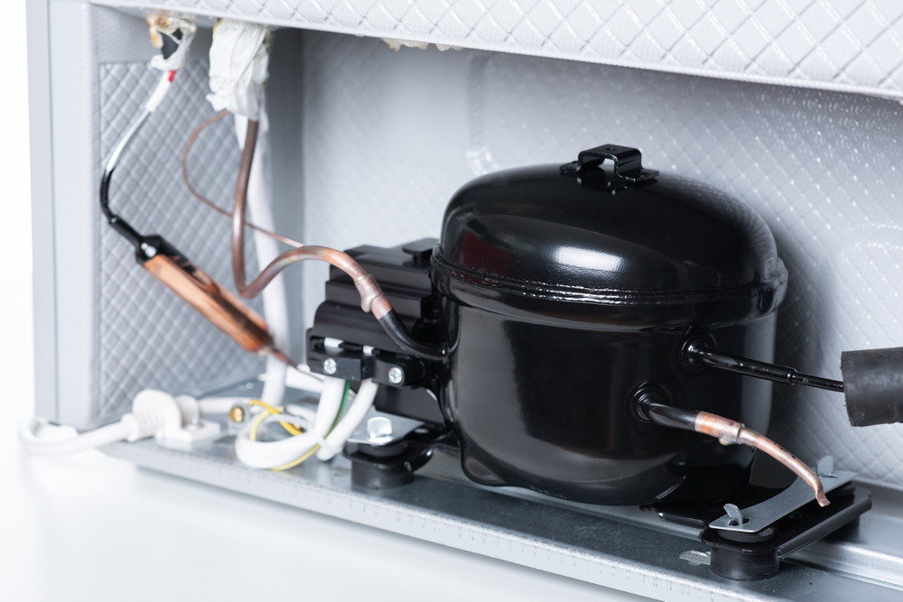 Close,up,refrigerator,compressor,mounted,on,the,minibar.