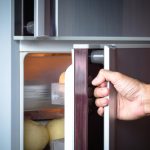 Abstract,hand,a,young,man,is,opening,a,refrigerator,door